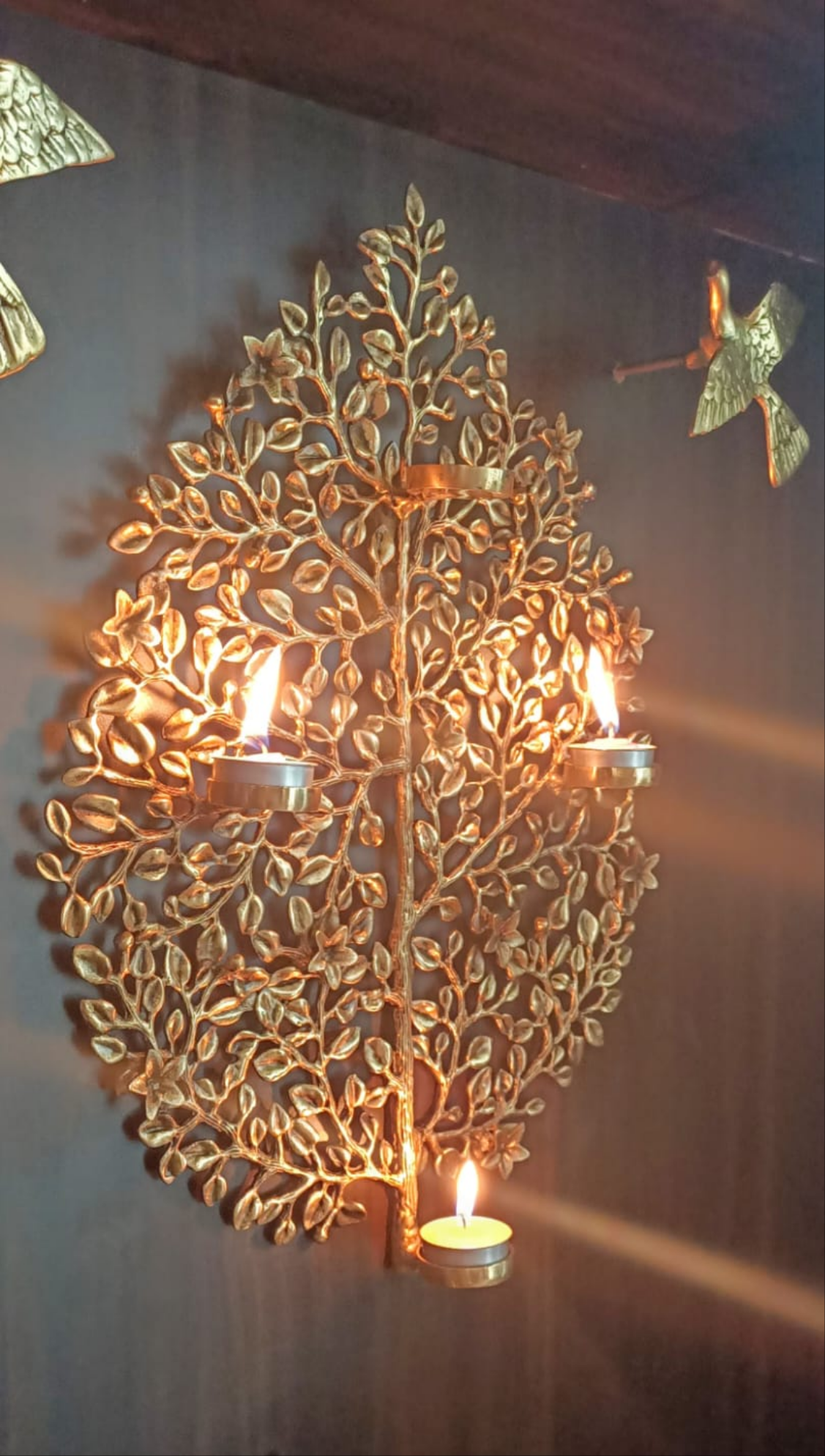 Decorative tree wall hang with candle holders.