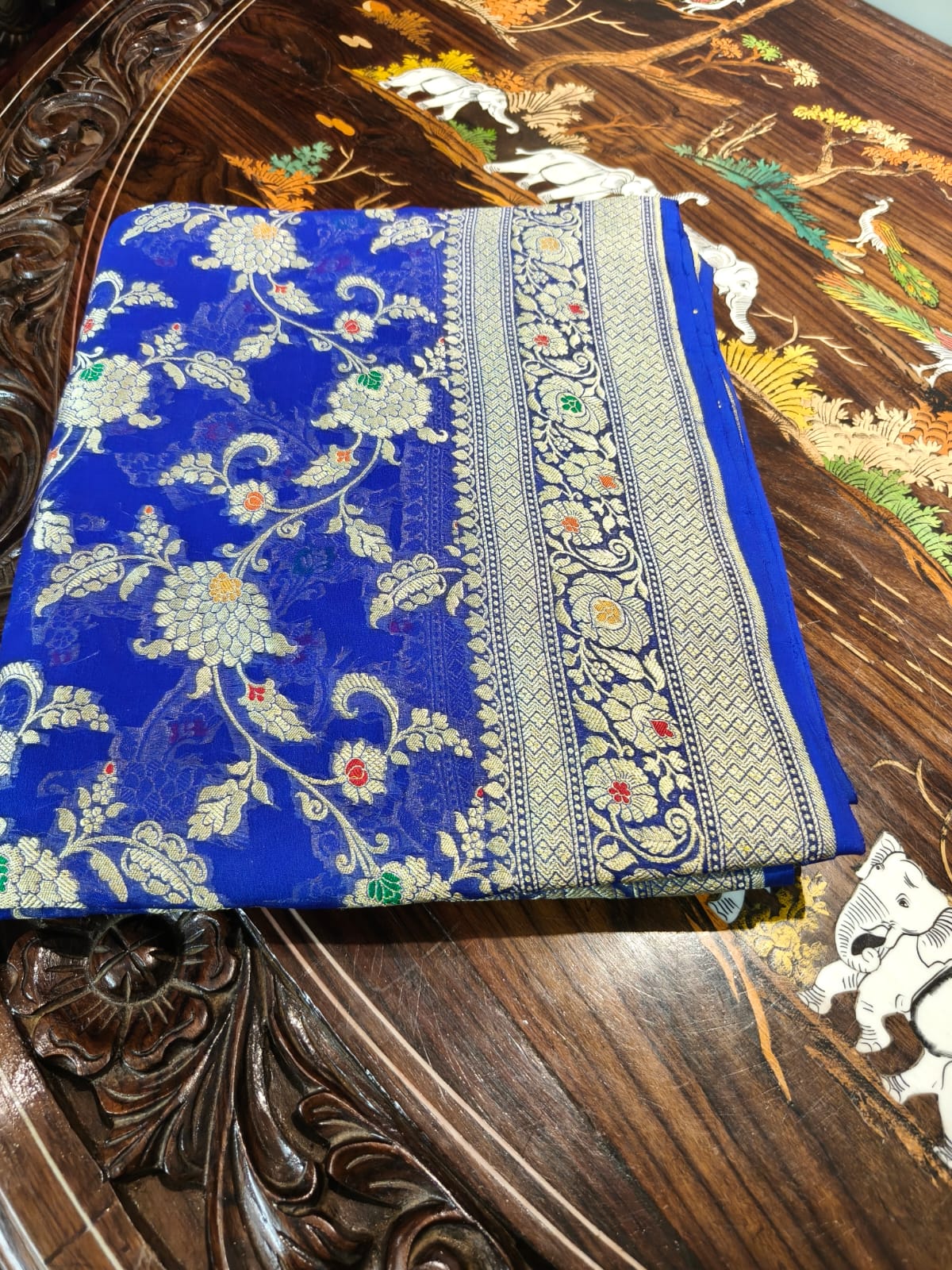 Pure silk blue with meena work is sheer and breathable silk hand woven with pure zari