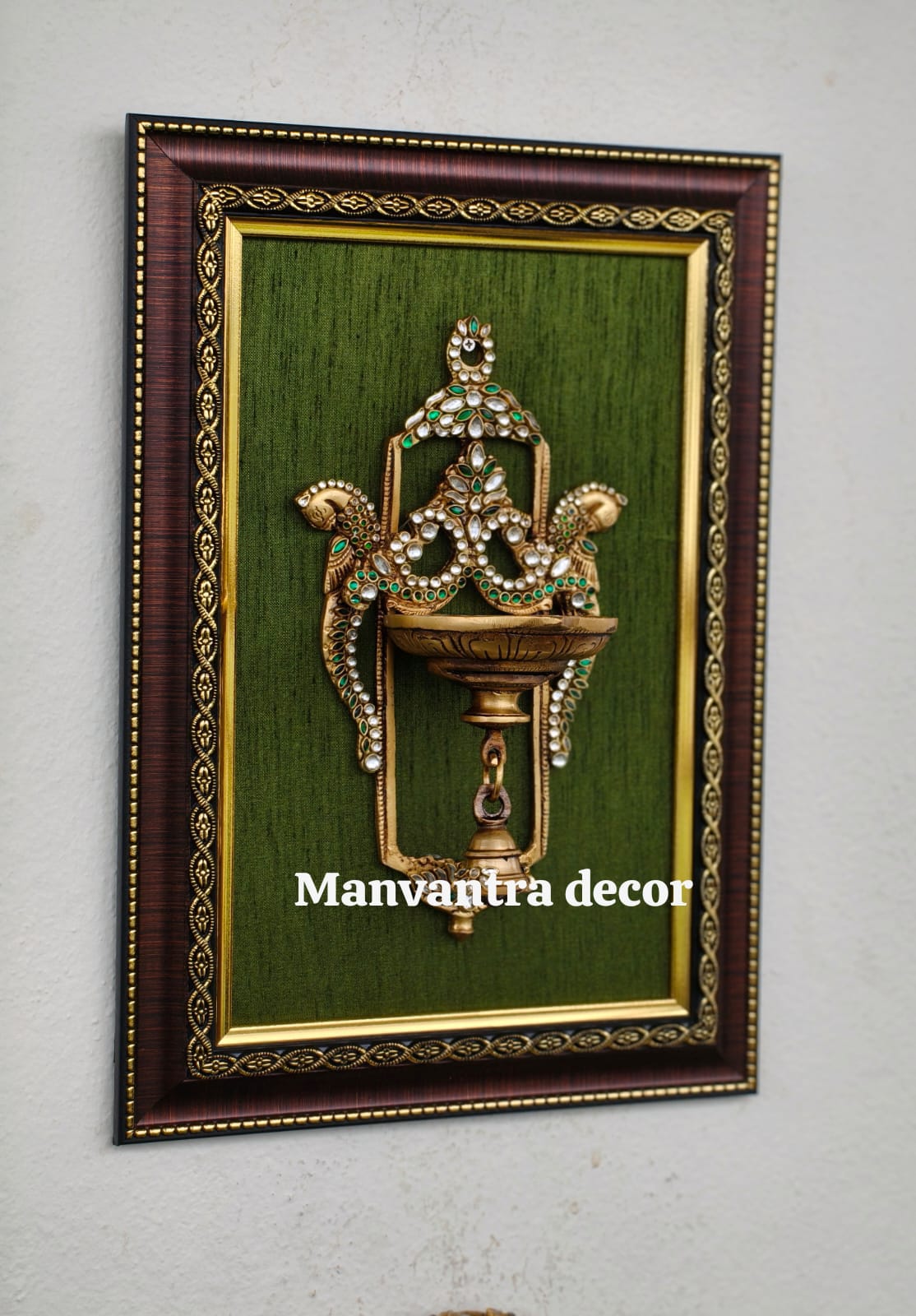 Framed wall-hang diyas (brass) add a touch of sparkle and elegance, a graceful highlight for your gallery wall.