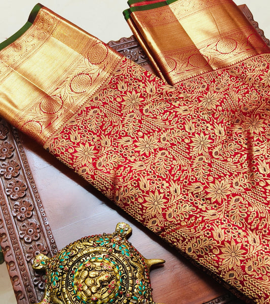 Red and golden saree with heavy floral pattern throughout