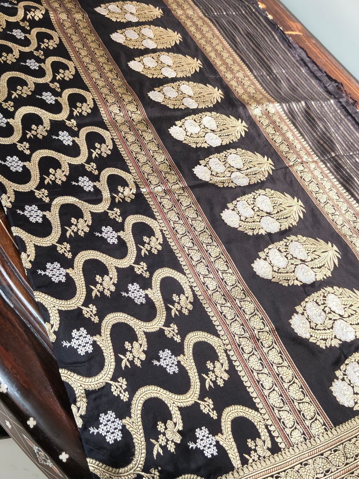 Pure Mulberry silk black with golden and silver zari work throughout the saree. 100% pure silk with pure zari completely hand weaved