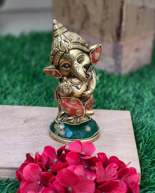 Cute baby Ganesha in pure brass with unique stonework done completely by hand.