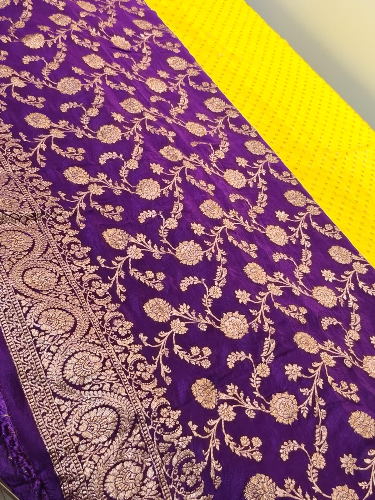 Pure crepe yellow with contrast wine colour silk saree in sheer, and breathable fabric traditionally woven from 100% mulberry silk and pure zari, completely hand weaved