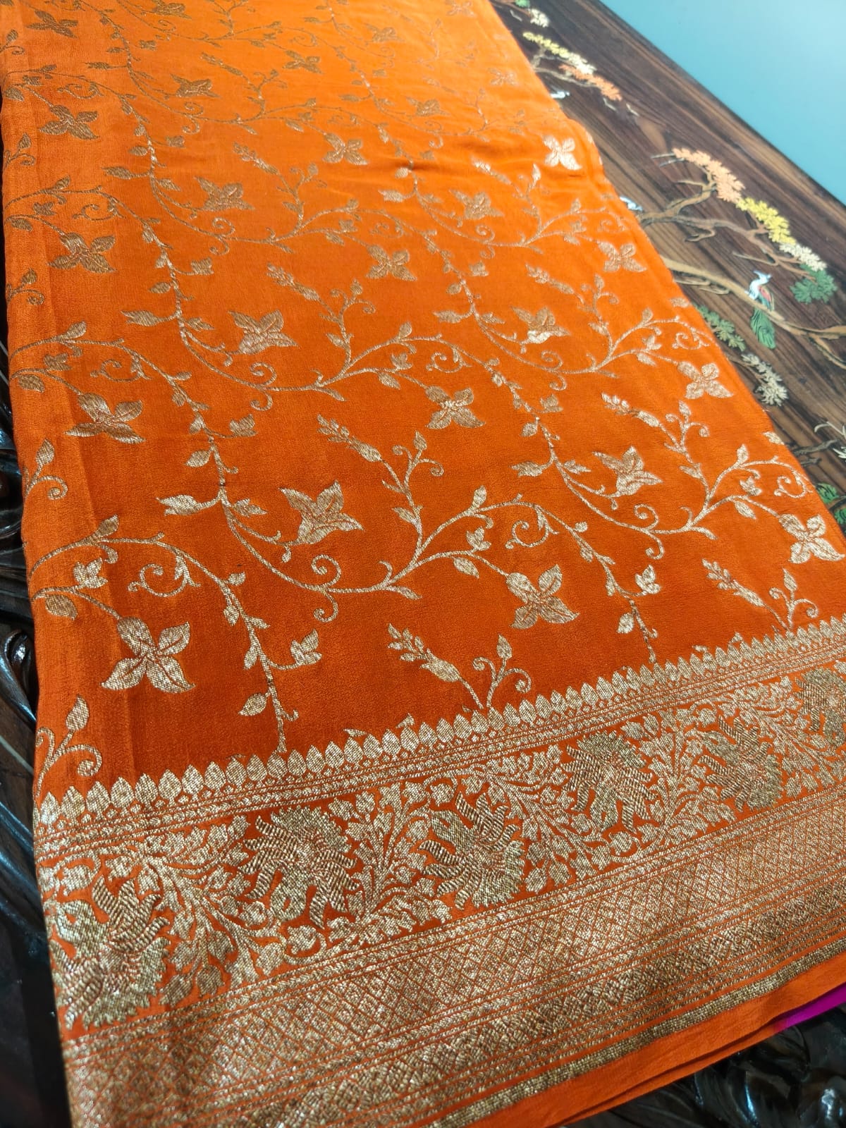 Pure crepe orange silk saree in sheer and breathable silk completely hand woven with pure zari