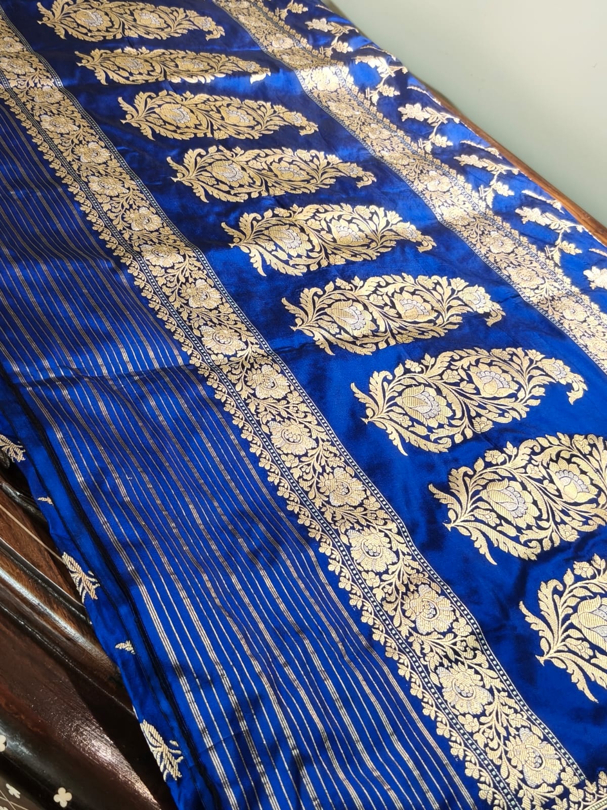 Pure Mulberry silk blue with golden and silver zari work throughout the saree. 100% pure silk with pure zari completely hand weaved