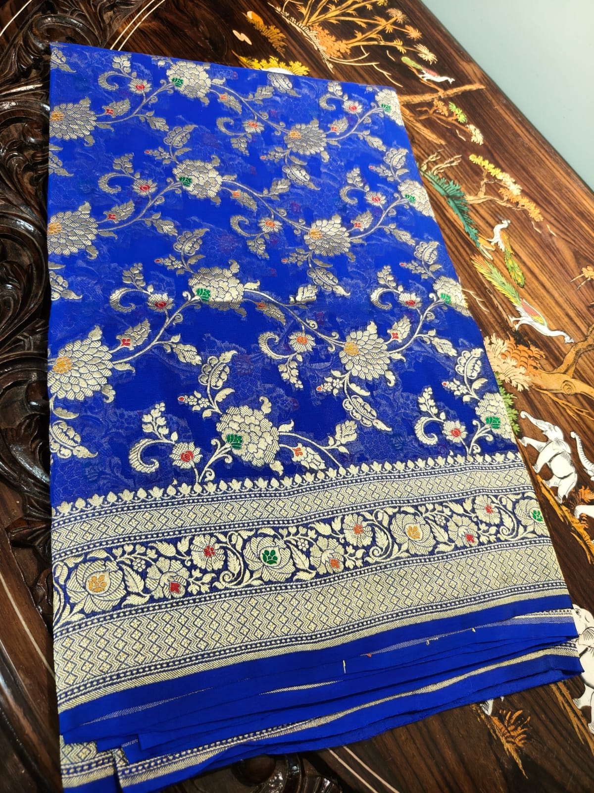 Pure silk blue with meena work is sheer and breathable silk hand woven with pure zari