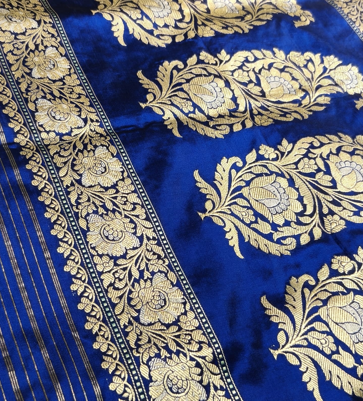 Pure Mulberry silk blue with golden and silver zari work throughout the saree. 100% pure silk with pure zari completely hand weaved