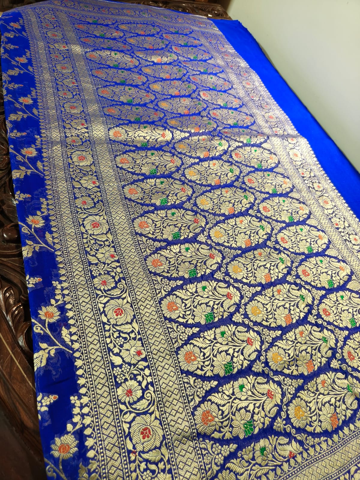 Pure silk blue with meena work is sheer and breathable silk hand woven with pure zari