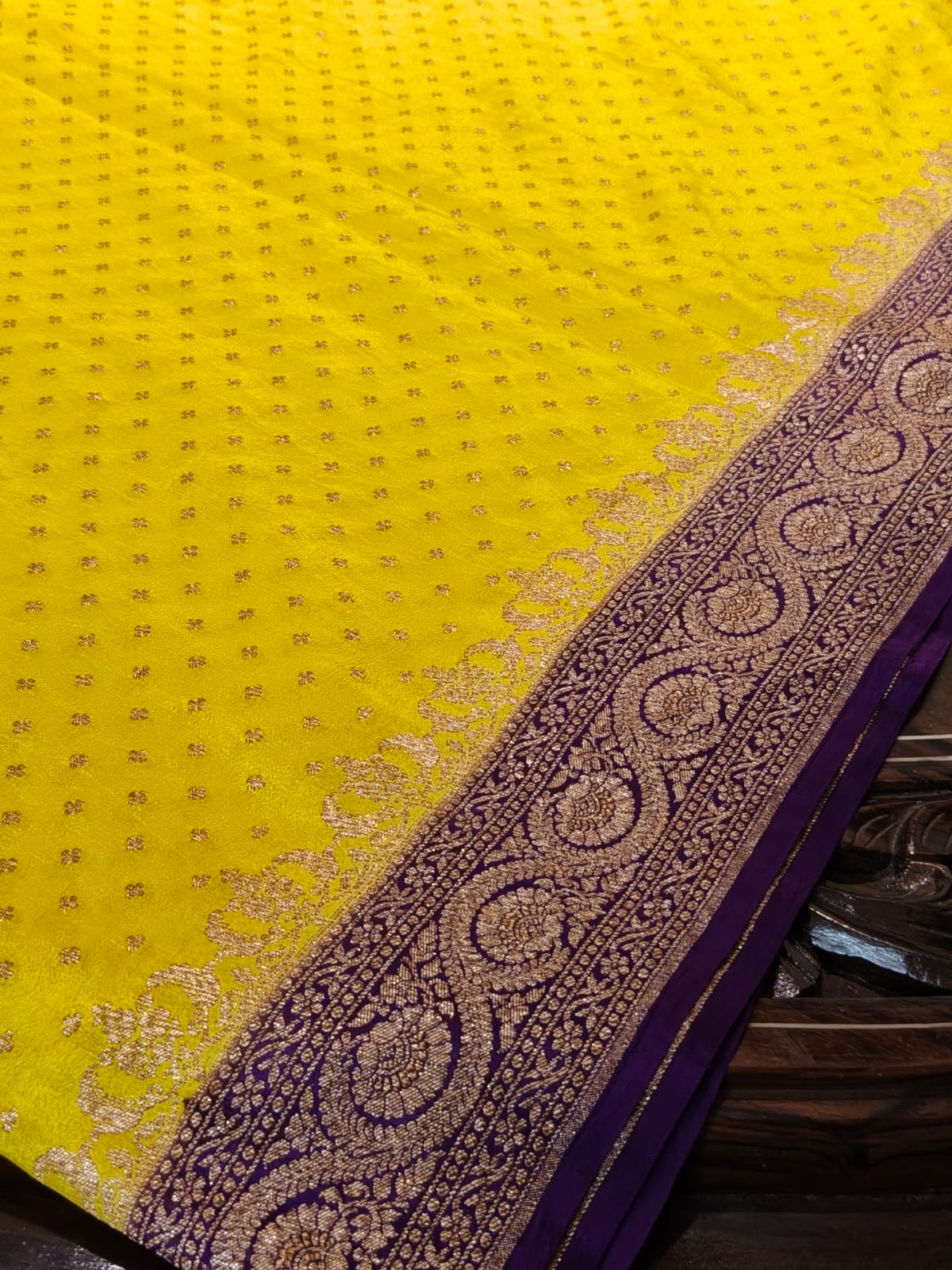 Pure crepe yellow with contrast wine colour silk saree in sheer, and breathable fabric traditionally woven from 100% mulberry silk and pure zari, completely hand weaved