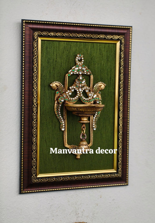 Framed wall-hang diyas (brass) add a touch of sparkle and elegance, a graceful highlight for your gallery wall.