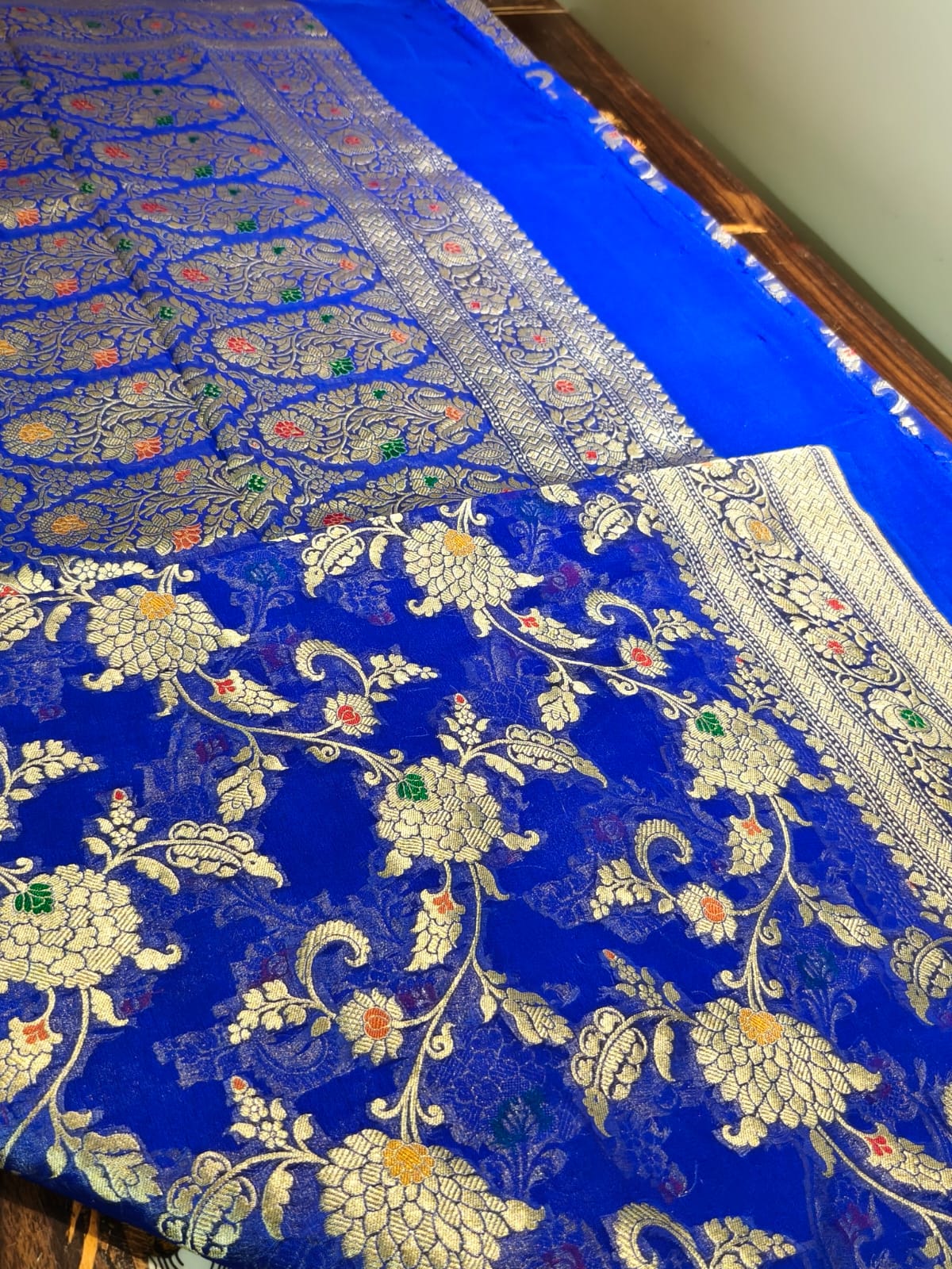 Pure silk blue with meena work is sheer and breathable silk hand woven with pure zari