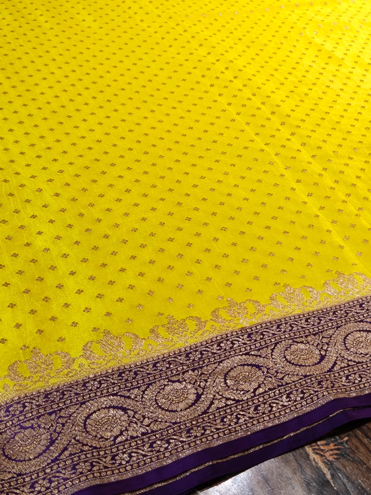 Pure crepe yellow with contrast wine colour silk saree in sheer, and breathable fabric traditionally woven from 100% mulberry silk and pure zari, completely hand weaved